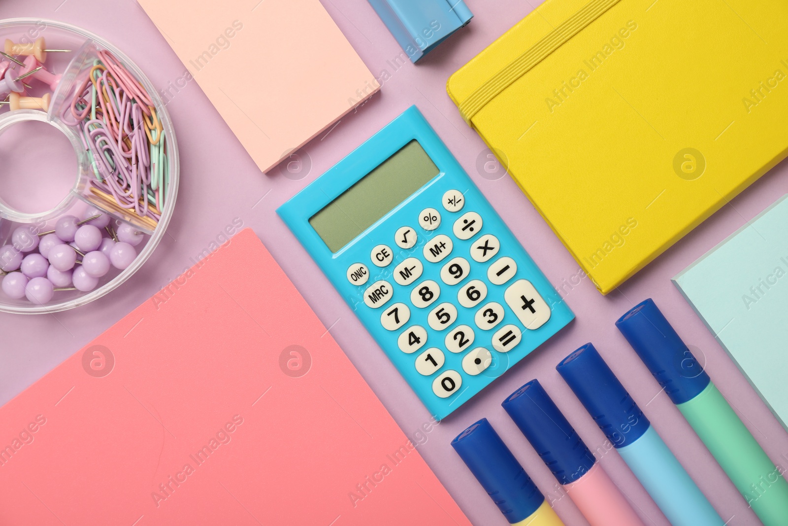 Photo of Flat lay composition with notebooks and different stationery on violet background