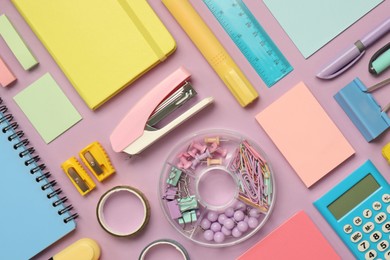 Flat lay composition with notebooks, stapler and different stationery on violet background