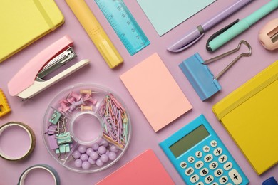 Photo of Flat lay composition with notebooks, stapler and different stationery on violet background