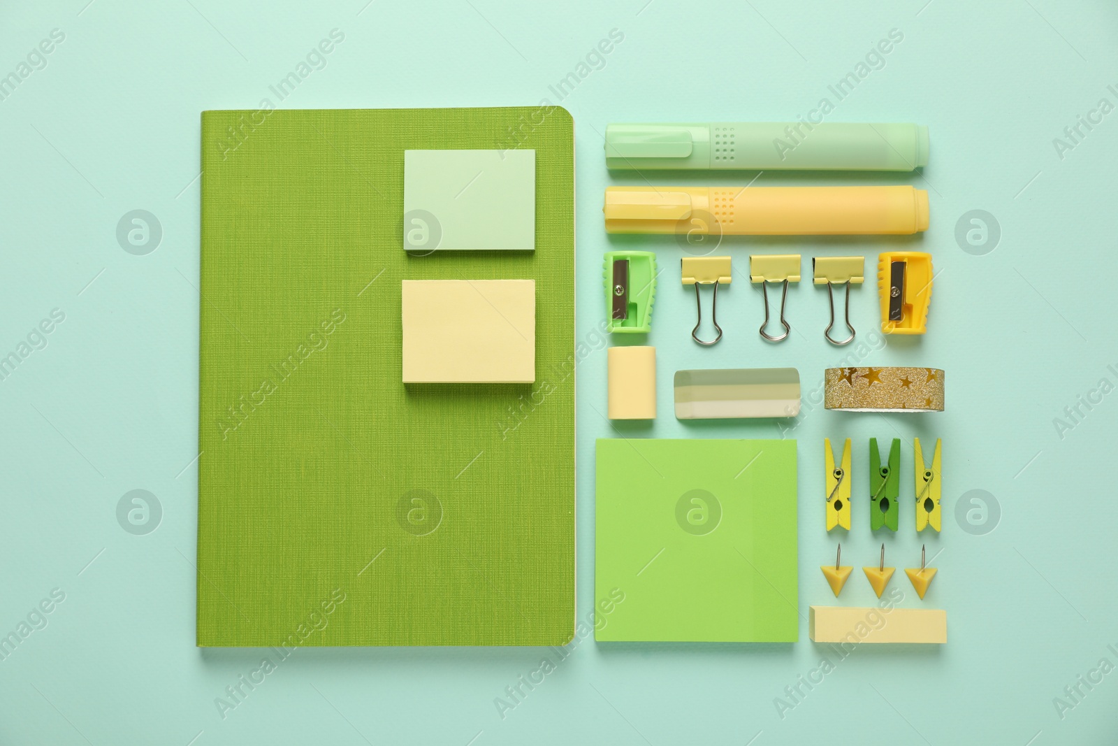 Photo of Flat lay composition with notebooks and different stationery on turquoise background