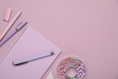 Flat lay composition with notebook and different stationery on violet background, space for text