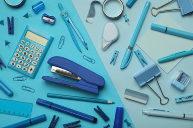 Flat lay composition with stapler and different stationery on light blue background