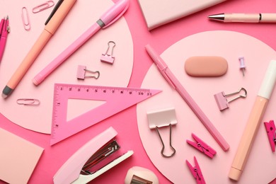 Photo of Flat lay composition with stapler and different stationery on pink background