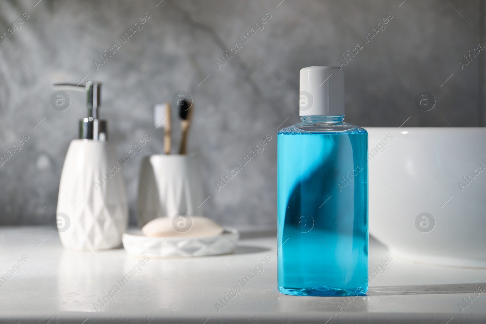 Photo of Bottle of mouthwash on light countertop in bathroom