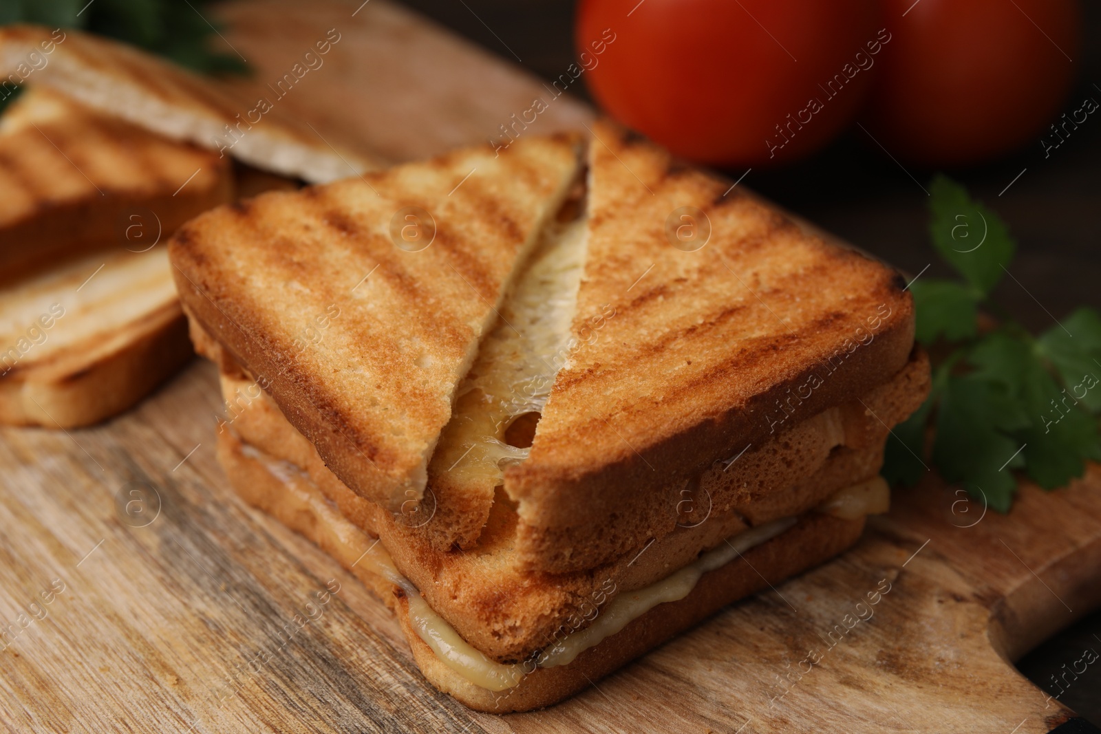 Photo of Pieces of toasted bread with melted cheese on table, closeup