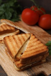 Pieces of toasted bread with melted cheese and tomatoes on table, closeup