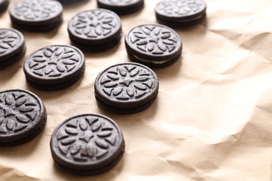 Photo of Many tasty sandwich cookies on parchment paper, space for text