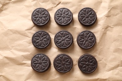 Tasty sandwich cookies on parchment paper, top view