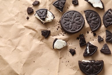 Tasty sandwich cookies on parchment paper, flat lay. Space for text