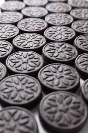 Photo of Many tasty sandwich cookies on table, closeup