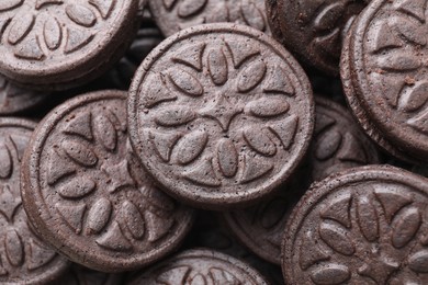 Photo of Tasty sandwich cookies as background, top view