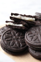 Photo of Many tasty sandwich cookies on table, closeup