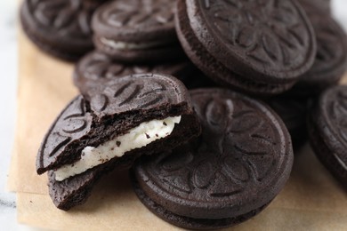 Photo of Many tasty sandwich cookies on table, closeup