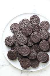 Tasty sandwich cookies on white marble table, top view