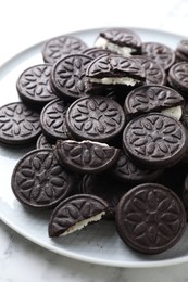 Photo of Tasty sandwich cookies on white marble table