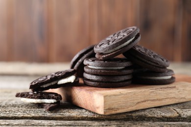 Photo of Many tasty sandwich cookies on wooden table