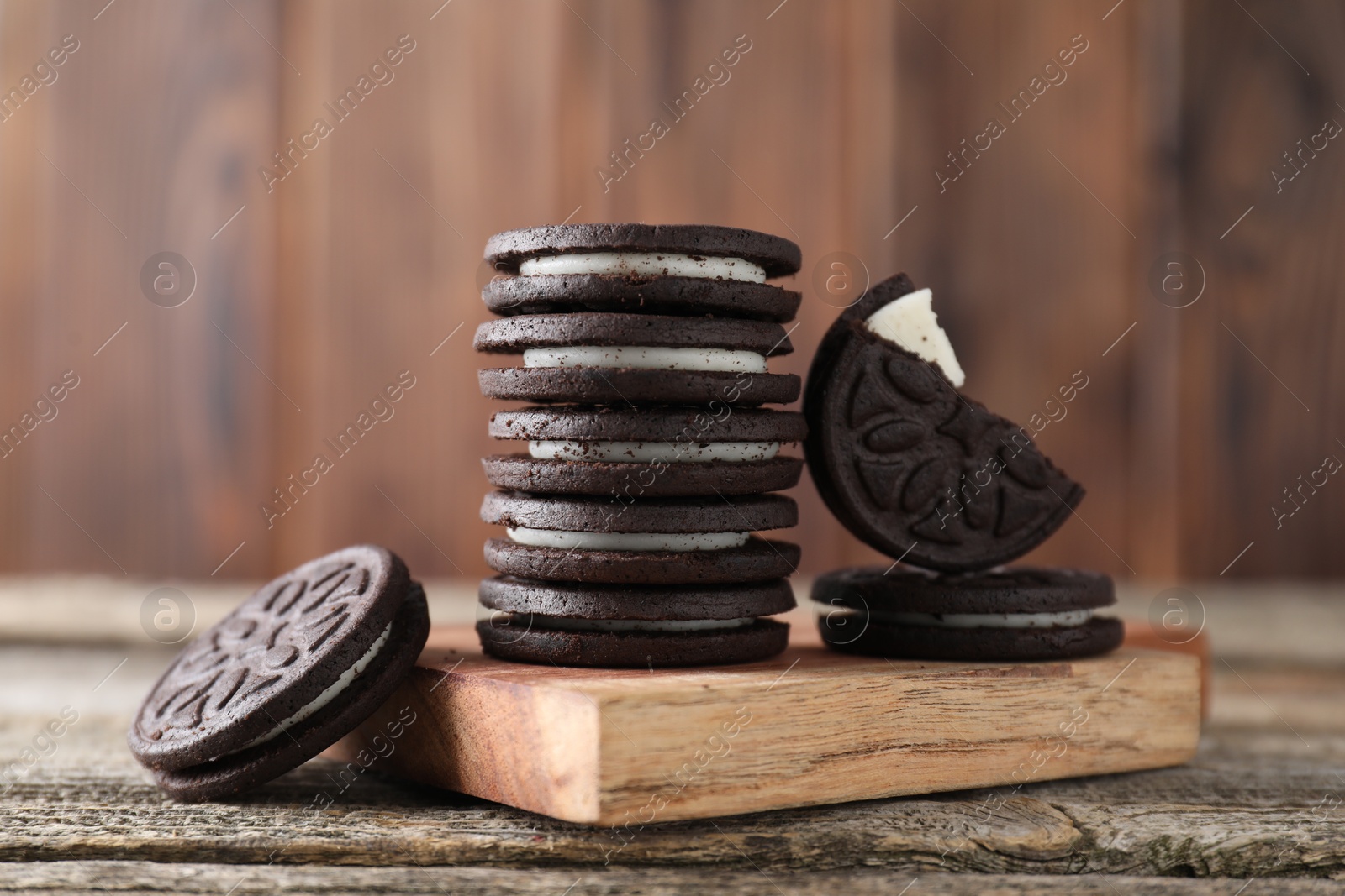 Photo of Many tasty sandwich cookies on wooden table