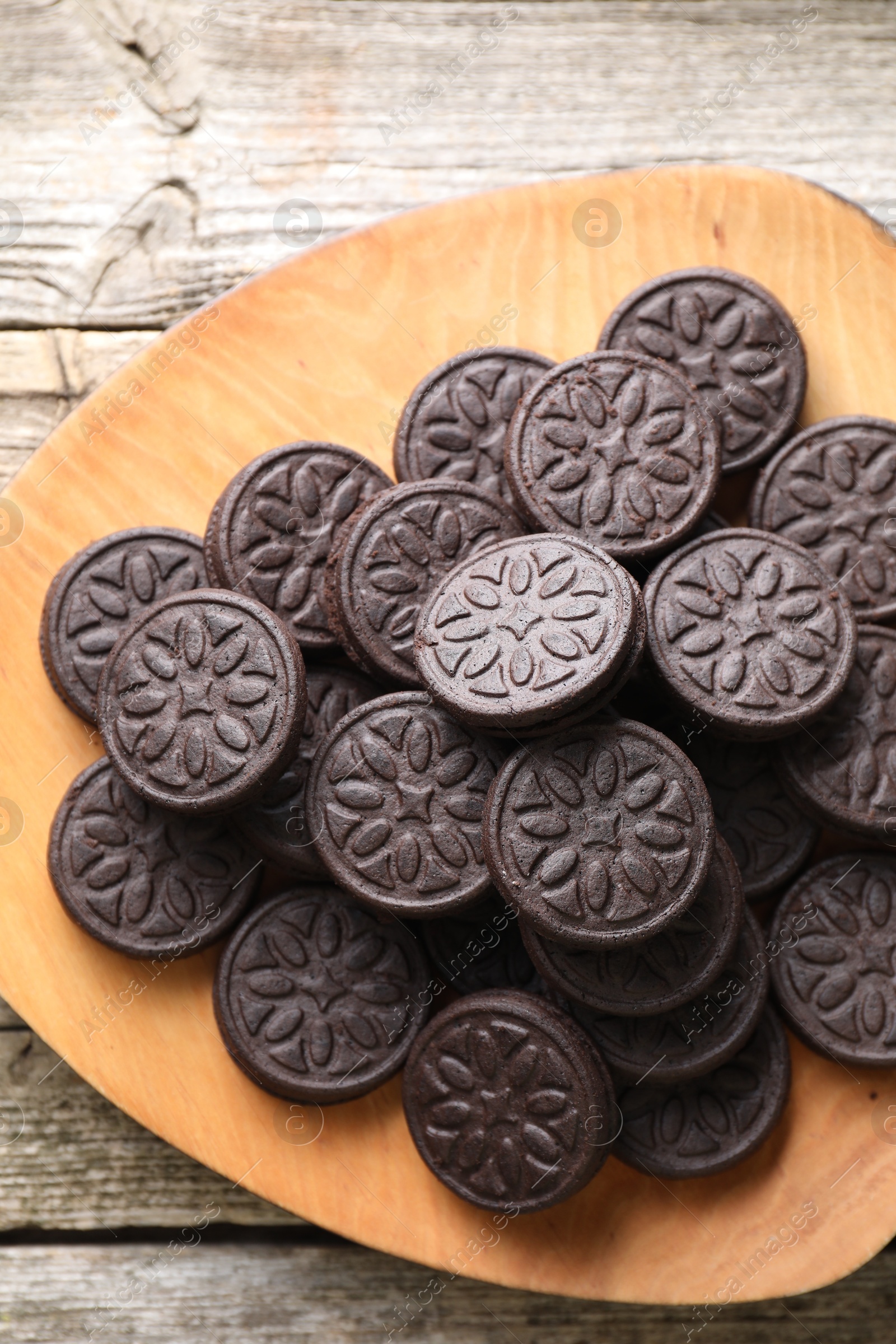 Photo of Many tasty sandwich cookies on wooden table, top view