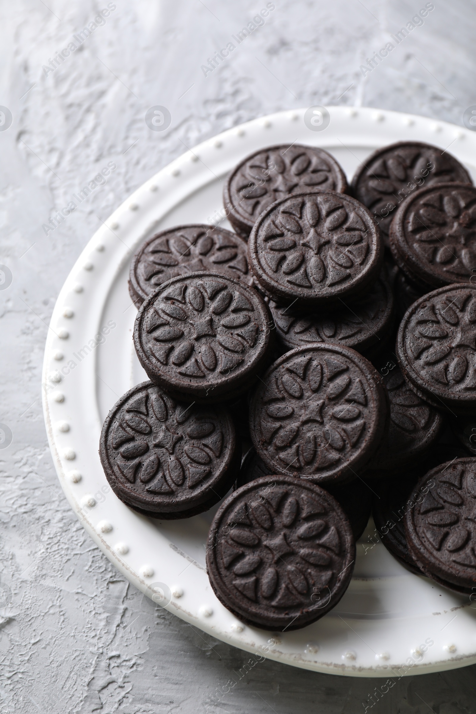 Photo of Many tasty sandwich cookies on light grey table, top view