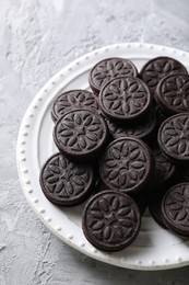 Many tasty sandwich cookies on light grey table, top view