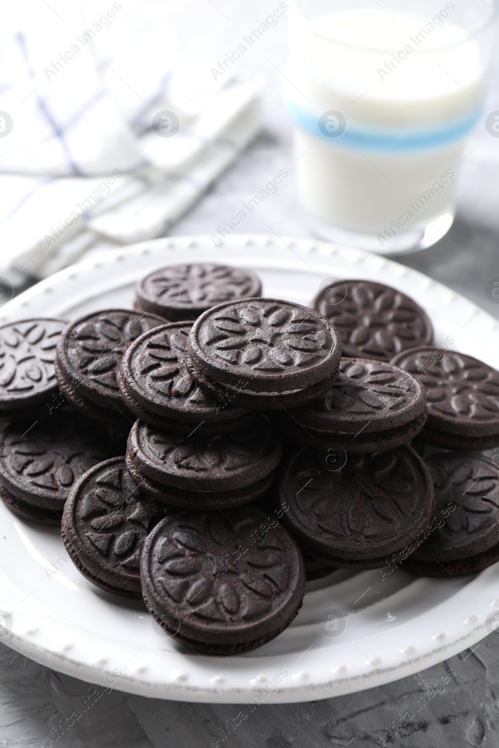 Photo of Many tasty sandwich cookies on light grey table