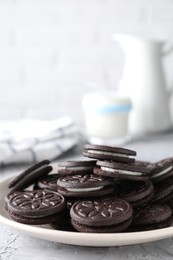 Photo of Many tasty sandwich cookies on light grey table