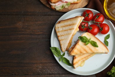 Pieces of toasted bread with melted cheese served on wooden table, top view. Space for text