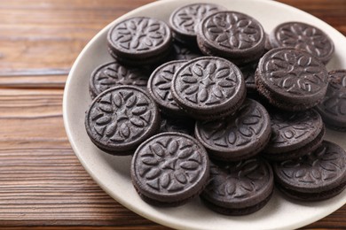 Photo of Many tasty sandwich cookies on wooden table