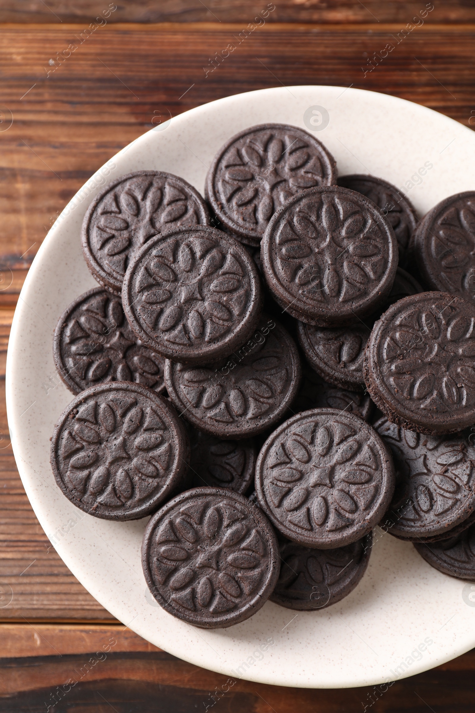 Photo of Many tasty sandwich cookies on wooden table, top view