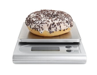 Photo of Kitchen scale with donut isolated on white