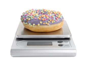 Photo of Kitchen scale with donut isolated on white