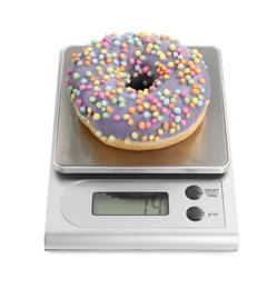 Photo of Kitchen scale with donut isolated on white