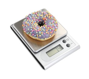 Photo of Kitchen scale with donut isolated on white