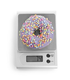 Photo of Kitchen scale with donut isolated on white, top view