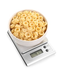 Photo of Kitchen scale with bowl of pasta isolated on white