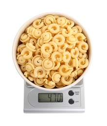 Kitchen scale with bowl of pasta isolated on white, top view