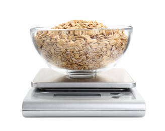 Photo of Kitchen scale with bowl of oats isolated on white