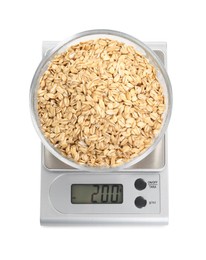 Photo of Kitchen scale with bowl of oats isolated on white, top view