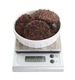 Photo of Kitchen scale with bowl of chocolate cookies isolated on white