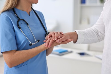 Professional doctor working with patient in hospital, closeup