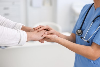 Photo of Professional doctor working with patient in hospital, closeup