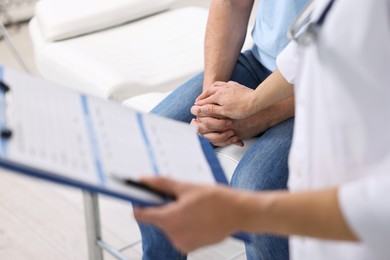 Photo of Professional doctor working with patient in hospital, closeup