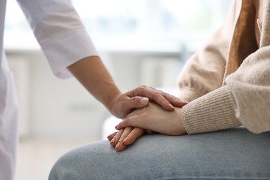 Photo of Professional doctor working with patient in hospital, closeup