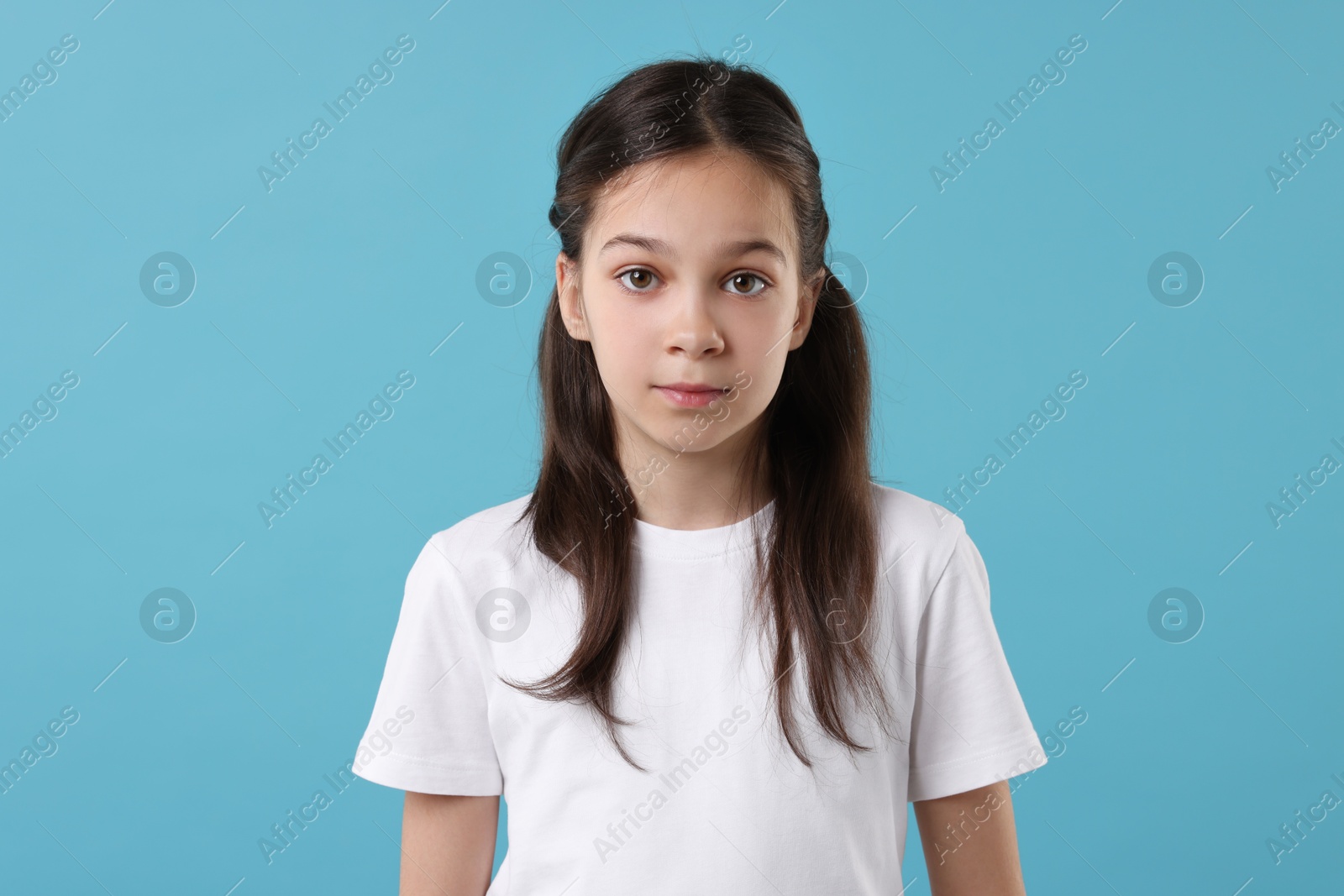 Photo of Portrait of beautiful girl on light blue background