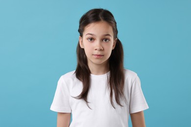 Photo of Portrait of beautiful girl on light blue background