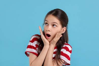 Photo of Portrait of emotional girl on light blue background