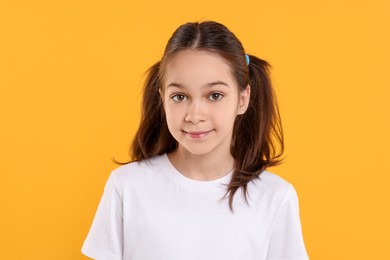 Photo of Portrait of beautiful girl on orange background