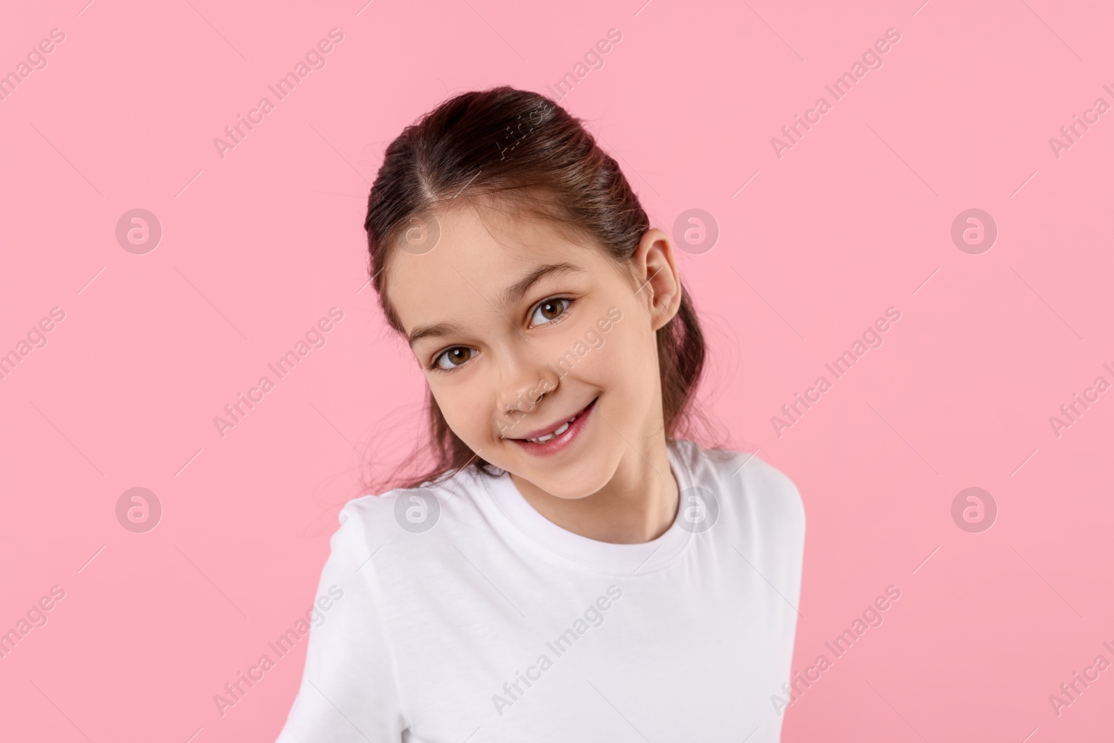 Photo of Portrait of happy girl on pink background