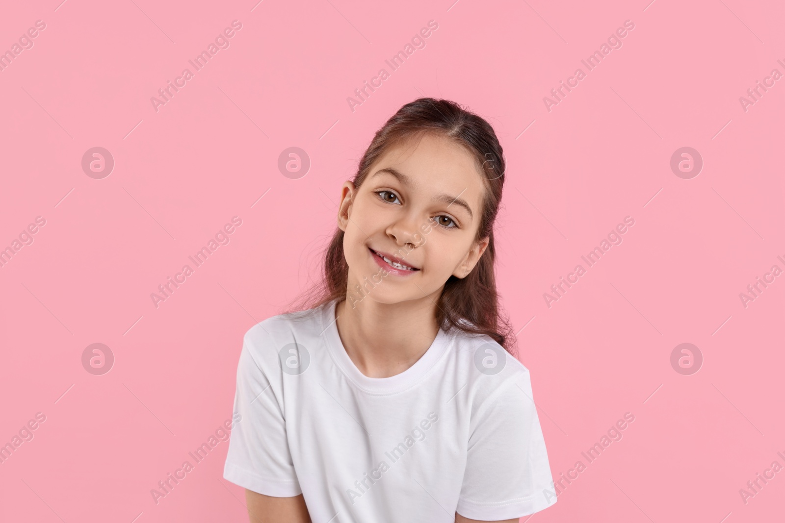 Photo of Portrait of happy girl on pink background