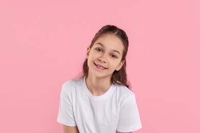 Portrait of happy girl on pink background